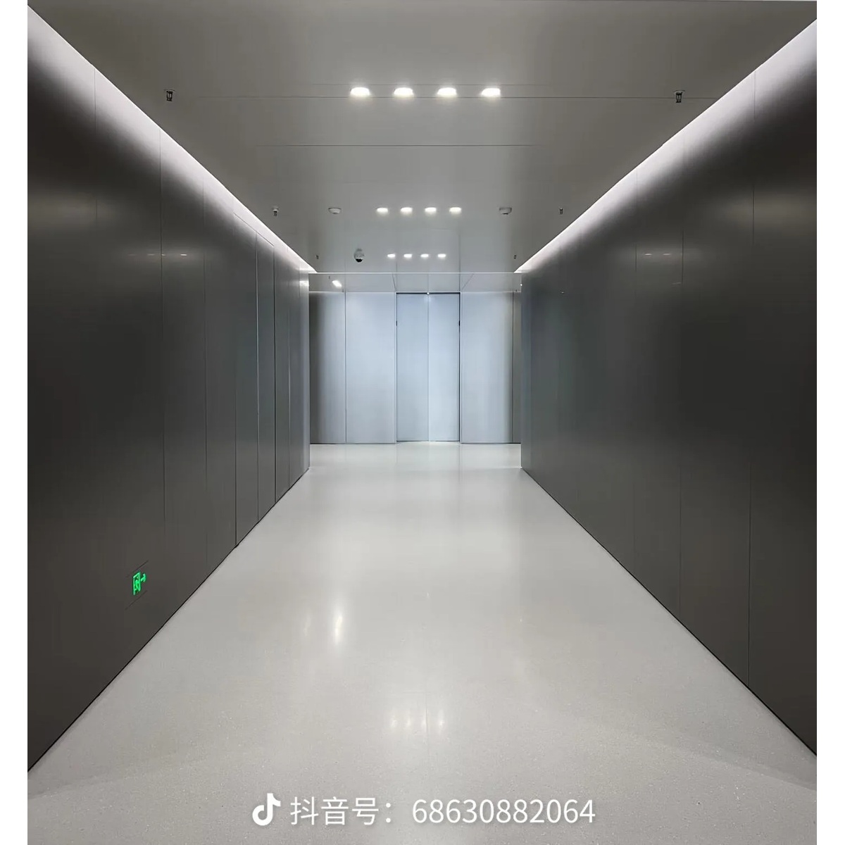 Interior corridor with metallic wall surfaces and linear lighting