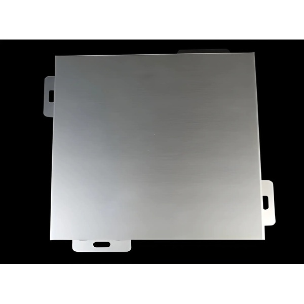 Grey folded cladding panel with perimeter fixing tabs against a dark background
